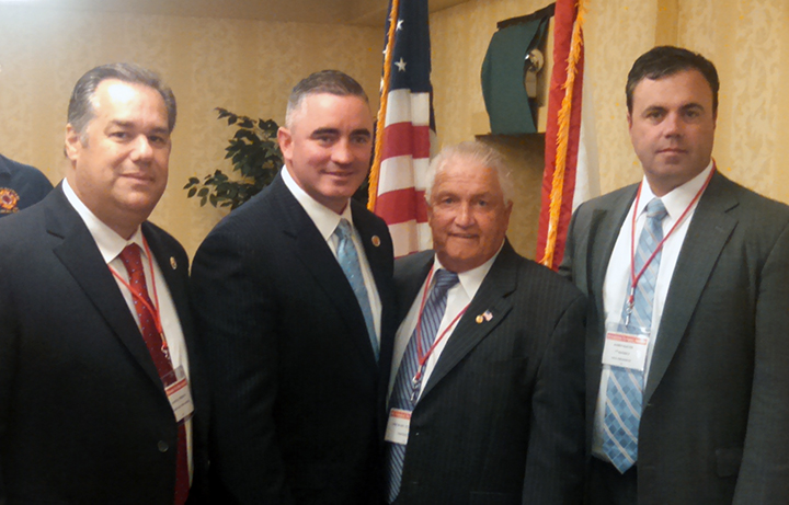 President Michael McManus, Secretary/Treasurer Sam Fresina, NYC UFA Vice President James Slevin congratulate Massachusetts state President Ed Kelly after receiving a unanimous endorsement from the NYSPFFA for the position of IAFF General Secretary/Treasurer.